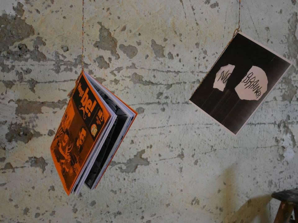 Two publications haning on strings at a wall
