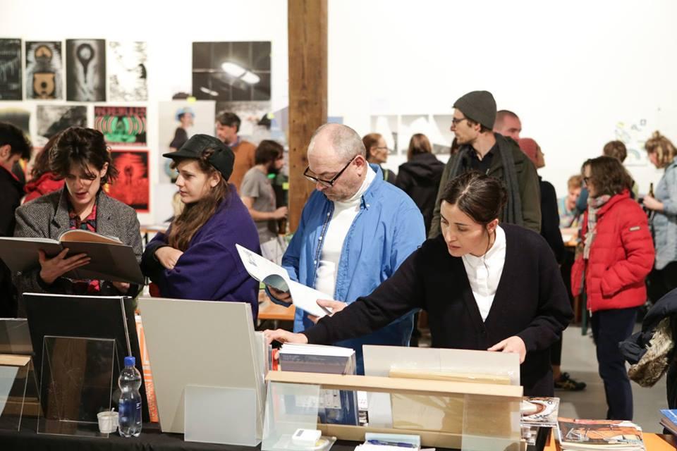 People looking at books at a book stand