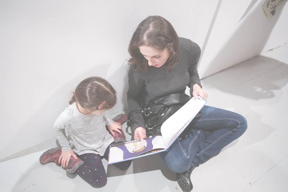 Mother and child looking at a book together